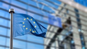 European Union flag against European Parliament European Union flag against European Parliament